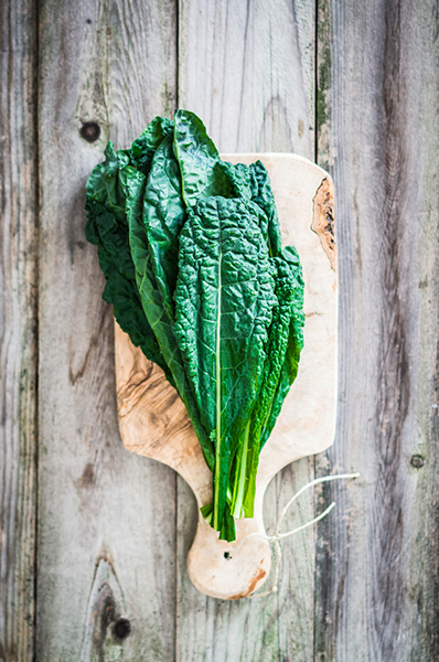 Kale on wooden background